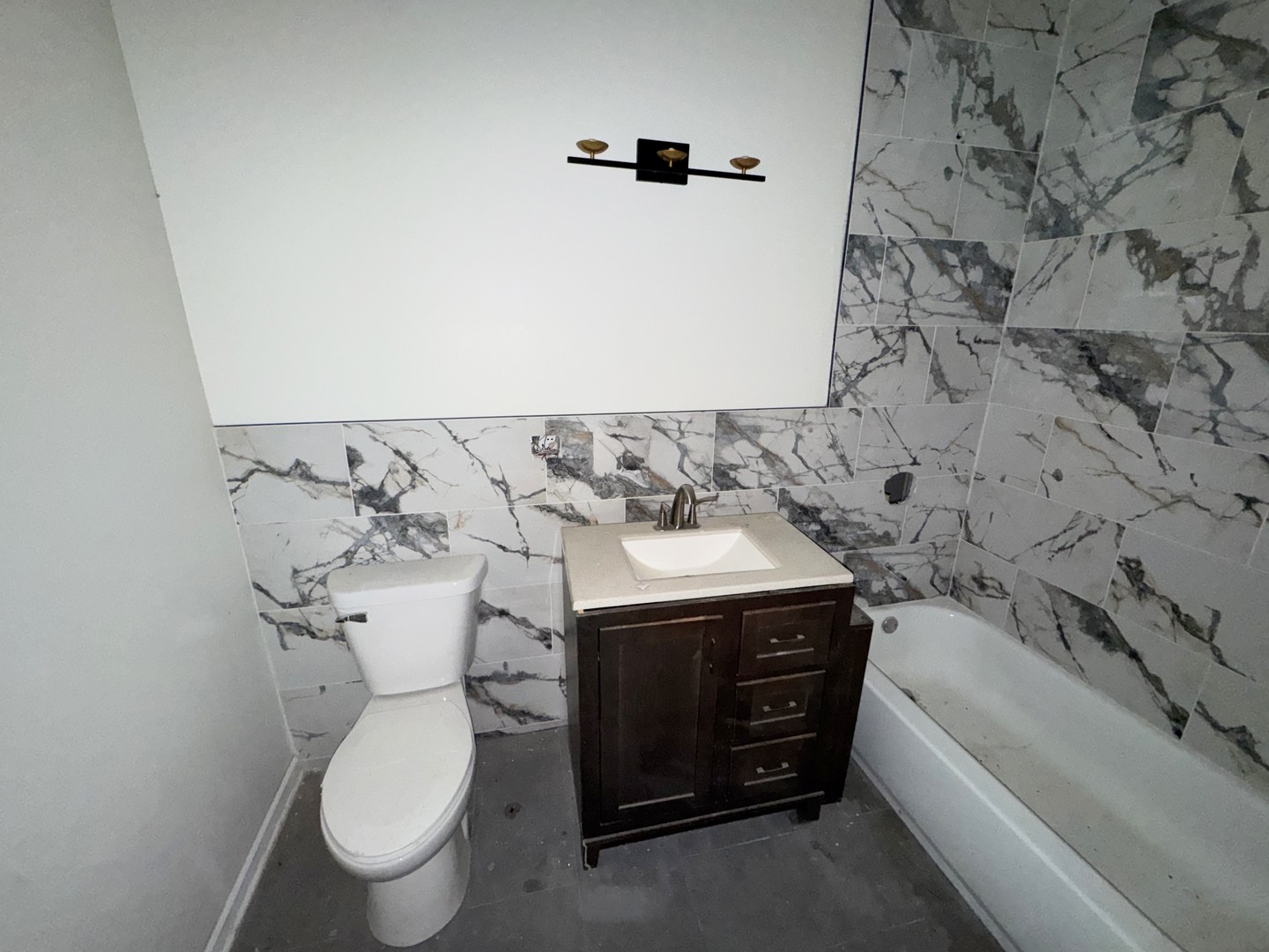 6227 South May Street Chicago, IL 60621 - Photo 9 of 13 a bathroom with a toilet and a sink