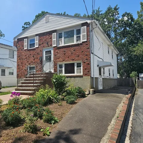 a front view of a house with garden