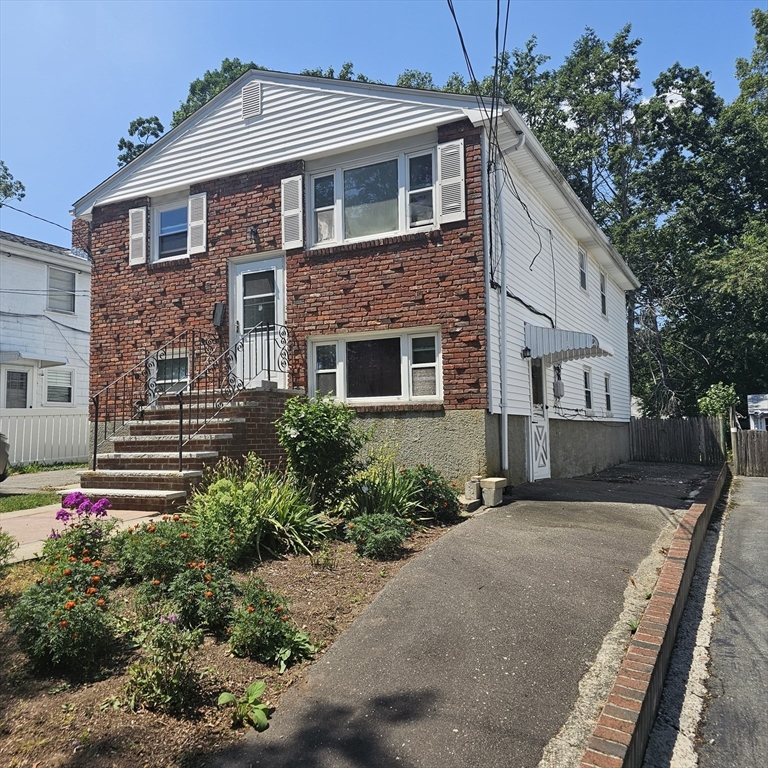 a front view of a house with garden