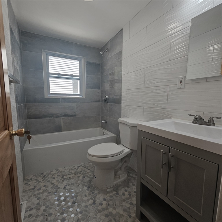 131 Itasca Street, Unit 2 Boston, MA 02126 - Photo 12 of 16 a bathroom with a sink toilet vanity and bathtub
