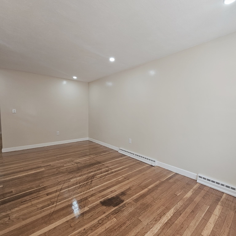 131 Itasca Street, Unit 2 Boston, MA 02126 - Photo 15 of 16 a view of empty room with wooden floor