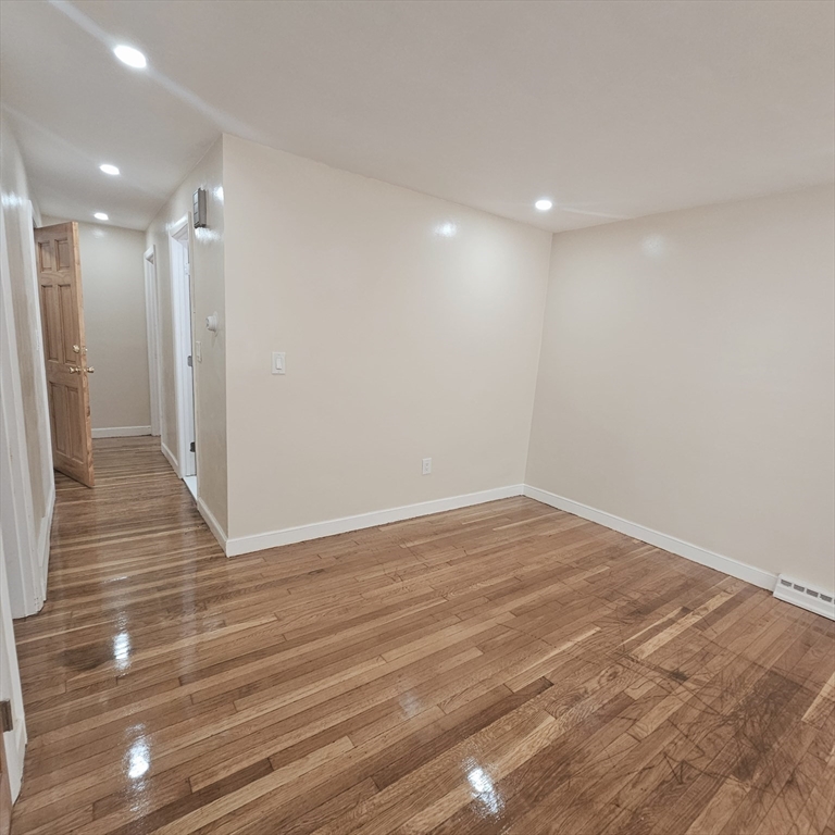 131 Itasca Street, Unit 2 Boston, MA 02126 - Photo 3 of 16 a view of empty room with wooden floor