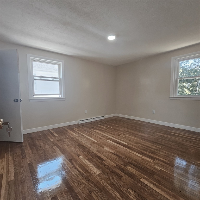 131 Itasca Street, Unit 2 Boston, MA 02126 - Photo 7 of 16 a view of empty room with wooden floor and fan