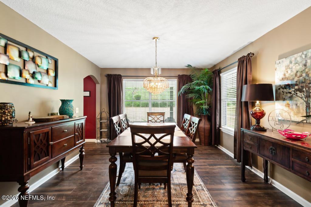 28317 Pike Road Hilliard, FL 32046 - Photo 12 of 42 a view of a dining room with furniture window and wooden floor