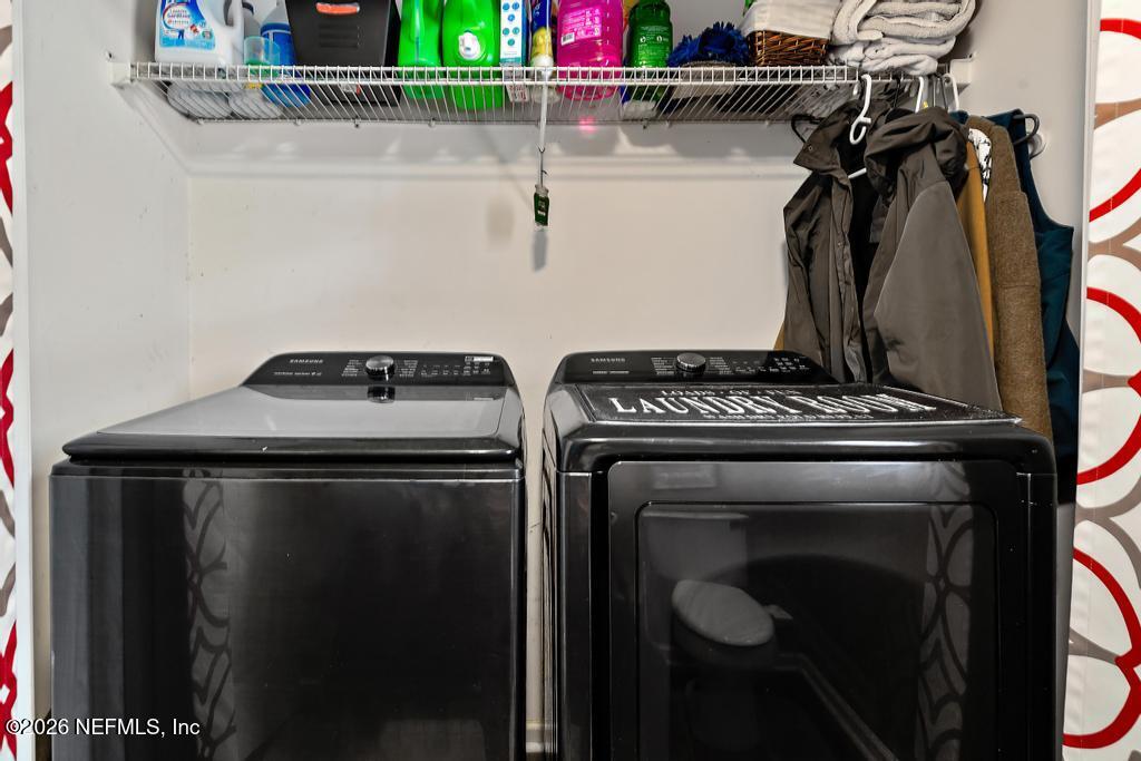 28317 Pike Road Hilliard, FL 32046 - Photo 15 of 42 a view of storage and utility room with washer and dryer