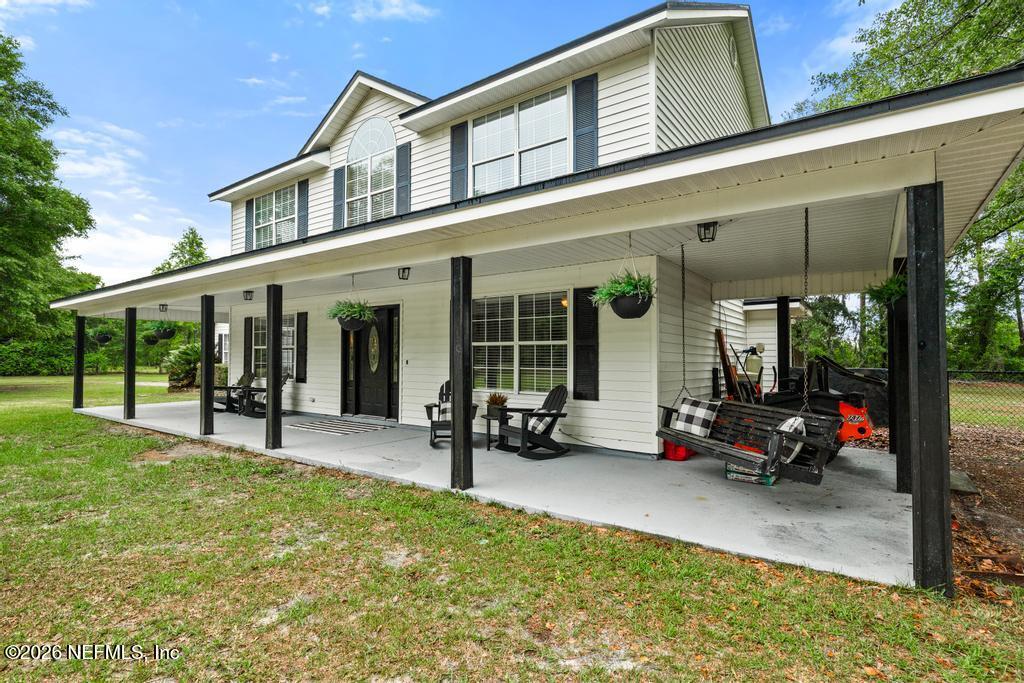 28317 Pike Road Hilliard, FL 32046 - Photo 2 of 42 a view of a house with sitting area and garden