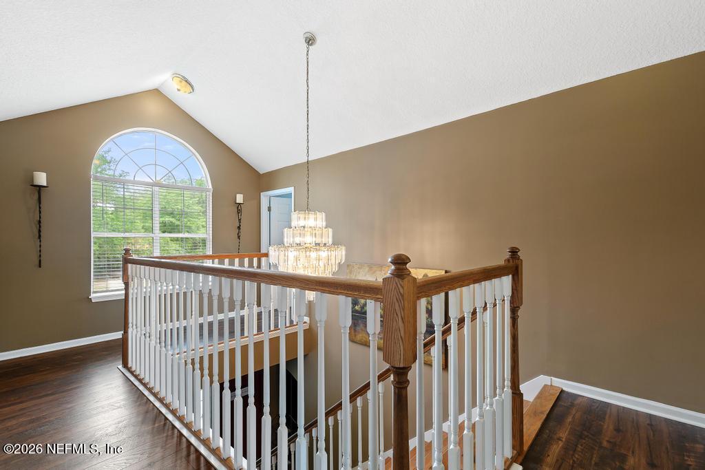 28317 Pike Road Hilliard, FL 32046 - Photo 24 of 42 a view of an empty room with wooden floor and windows