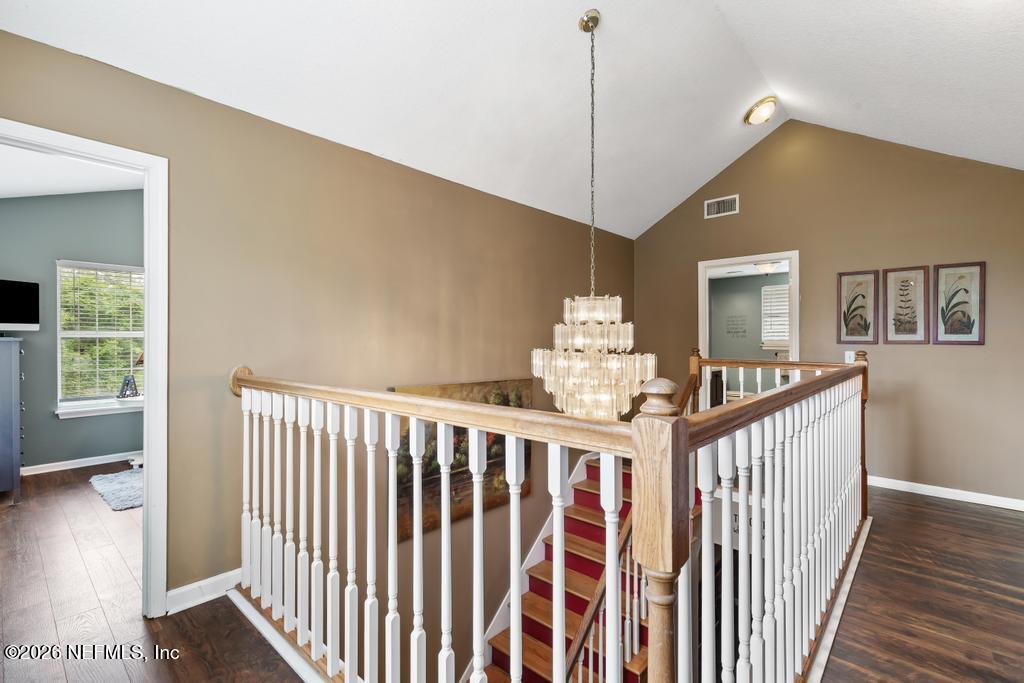 28317 Pike Road Hilliard, FL 32046 - Photo 25 of 42 a view of a hallway with wooden floor and windows