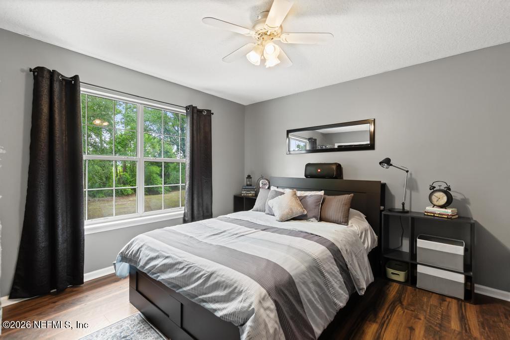 28317 Pike Road Hilliard, FL 32046 - Photo 26 of 42 a bedroom with a bed and a table