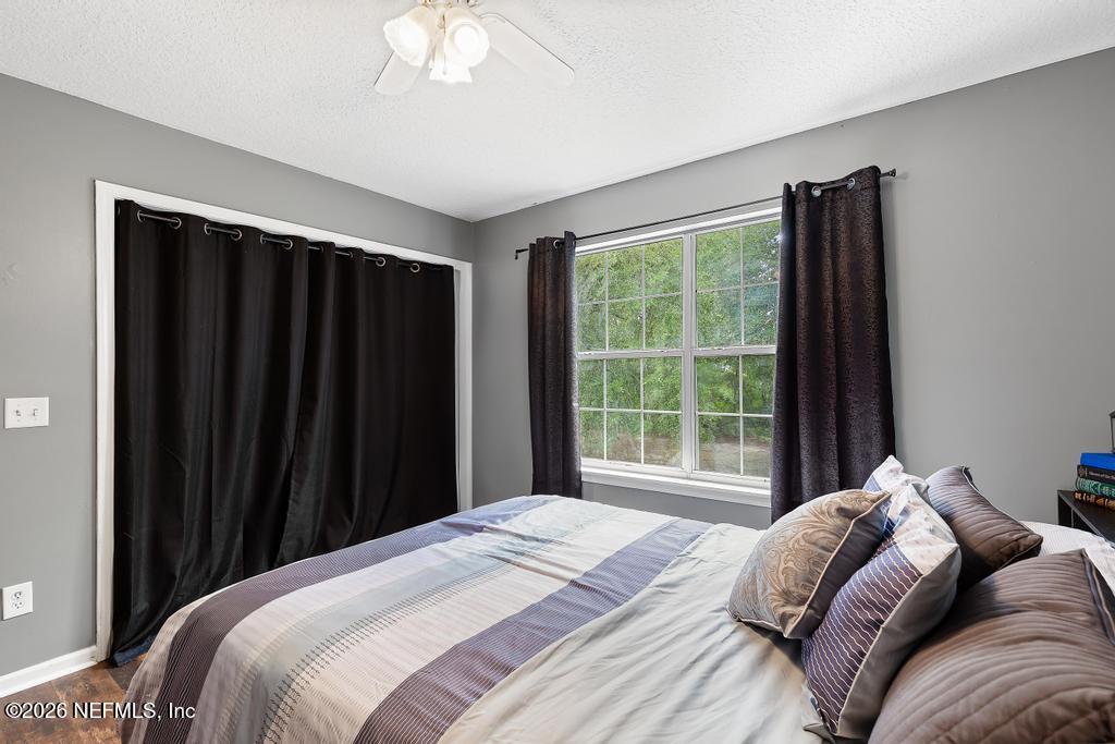 28317 Pike Road Hilliard, FL 32046 - Photo 27 of 42 a bedroom with a bed and a large window