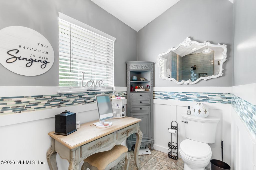 28317 Pike Road Hilliard, FL 32046 - Photo 34 of 42 a bathroom with a toilet sink and mirror