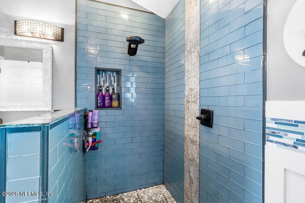 28317 Pike Road Hilliard, FL 32046 - Photo 35 of 42 a bathroom with a shower and a sink