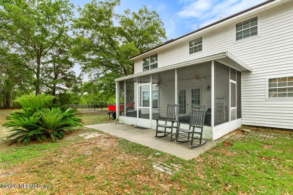 28317 Pike Road Hilliard, FL 32046 - Photo 37 of 42 a view of a house with backyard and sitting area