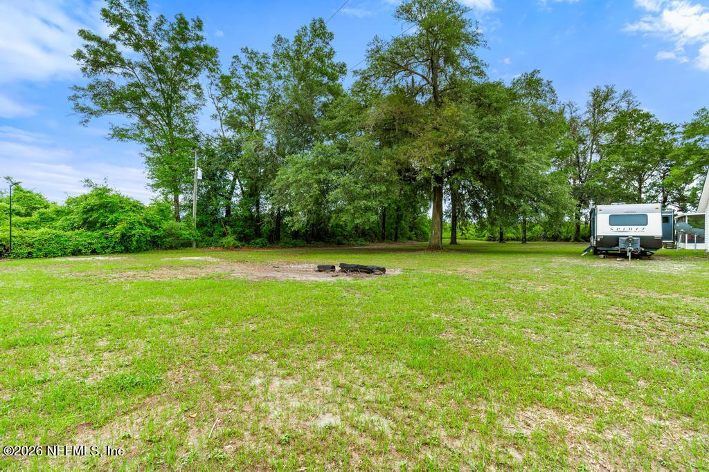 28317 Pike Road Hilliard, FL 32046 - Photo 38 of 42 a view of a green field with trees in the background
