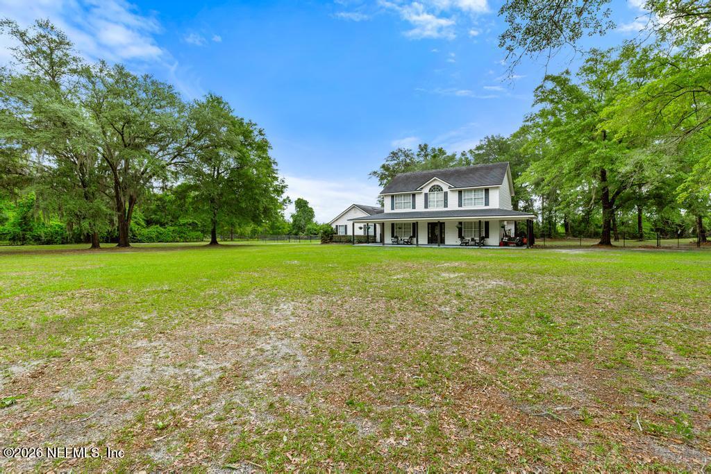 28317 Pike Road Hilliard, FL 32046 - Photo 42 of 42 a front view of a house with a big yard