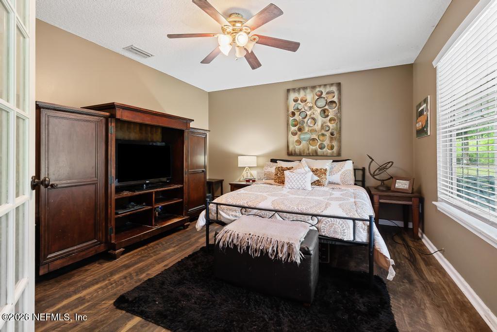 28317 Pike Road Hilliard, FL 32046 - Photo 8 of 42 a bedroom with a bed and a flat screen tv