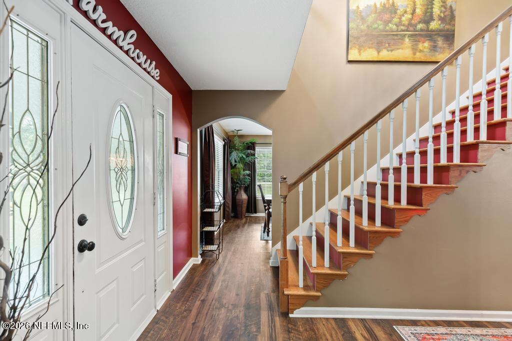 28317 Pike Road Hilliard, FL 32046 - Photo 10 of 42 a view of an entryway wooden floor with windows