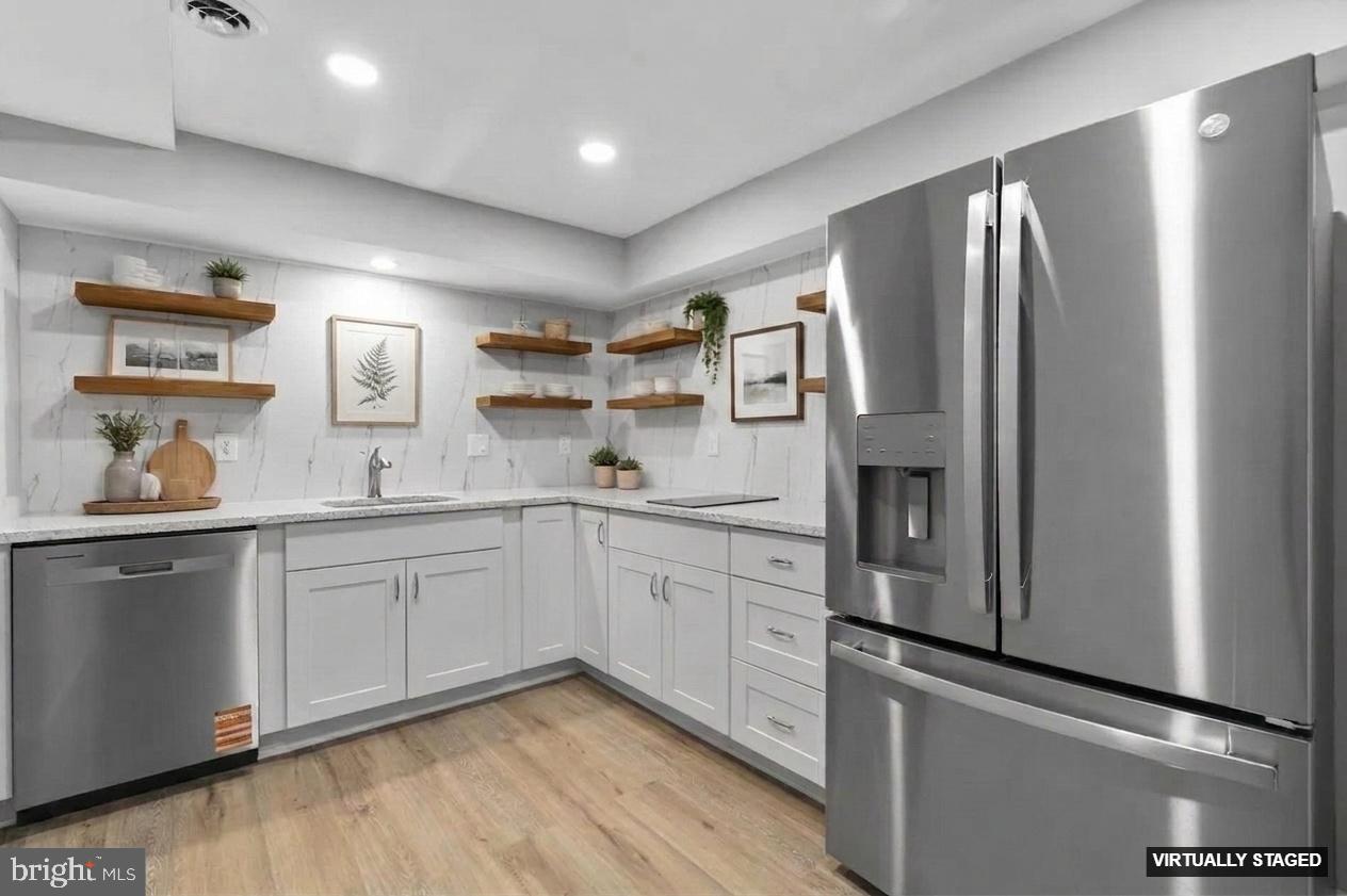 24320 Log House Road Gaithersburg, MD 20882 - Photo 29 of 43 a kitchen with stainless steel appliances granite countertop a refrigerator and a sink