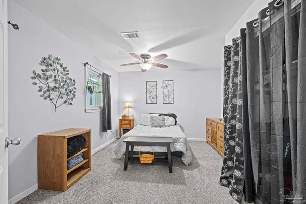 a bedroom with a bed and large window