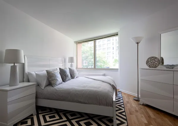 a bedroom with a bed and a window