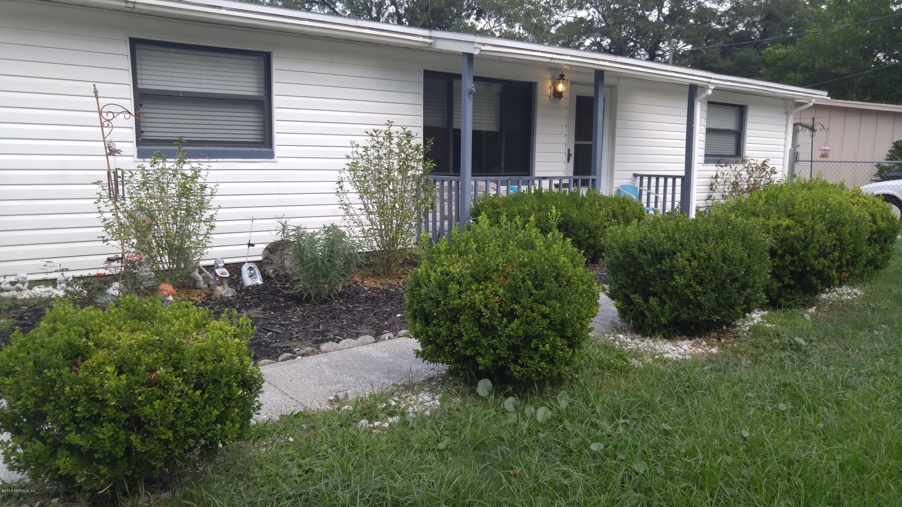 445 Sigsbee Road Orange Park, FL 32073 - Photo 3 of 32 a view of backyard with potted plants and floor to ceiling window