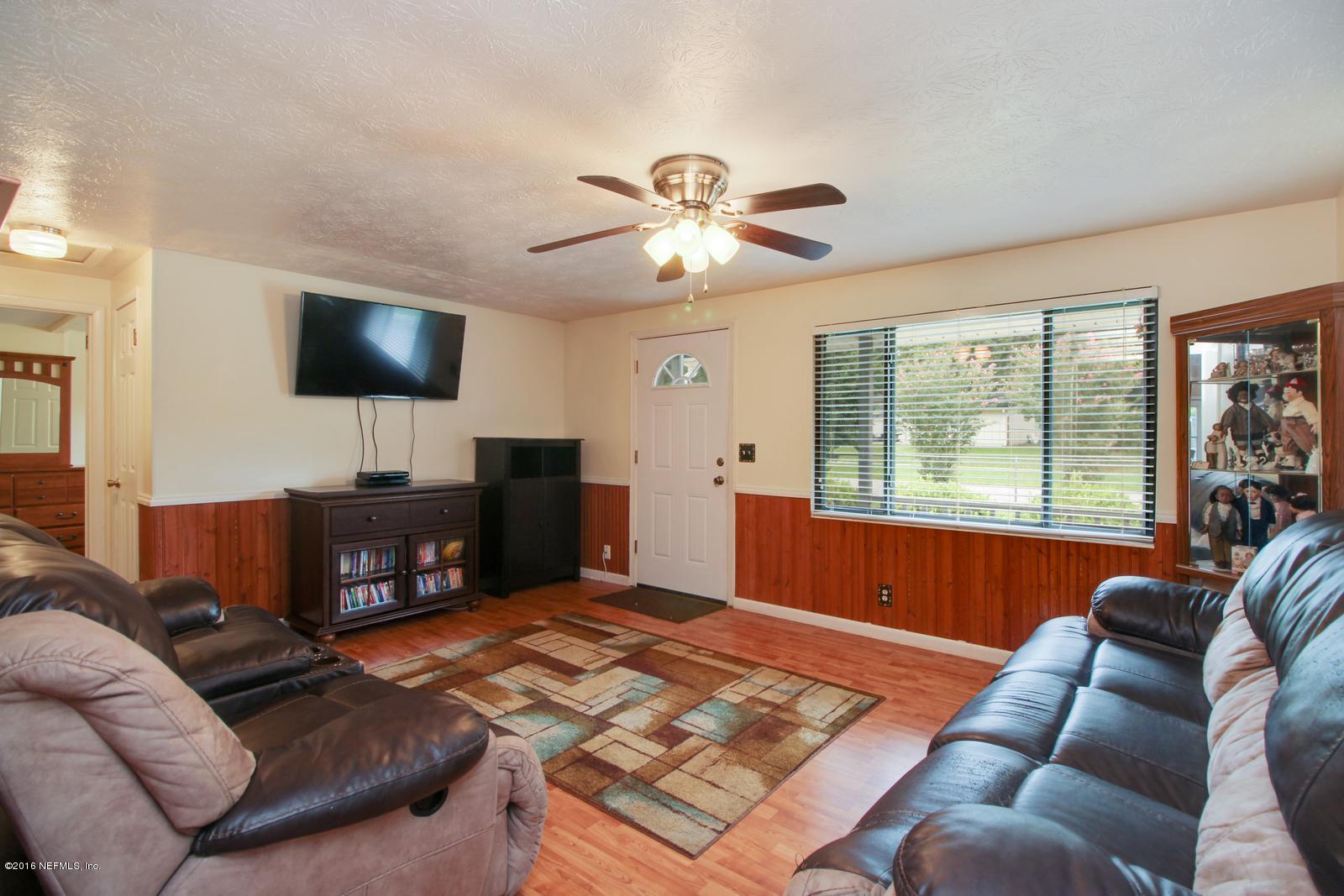 445 Sigsbee Road Orange Park, FL 32073 - Photo 5 of 32 a living room with furniture and a flat screen tv