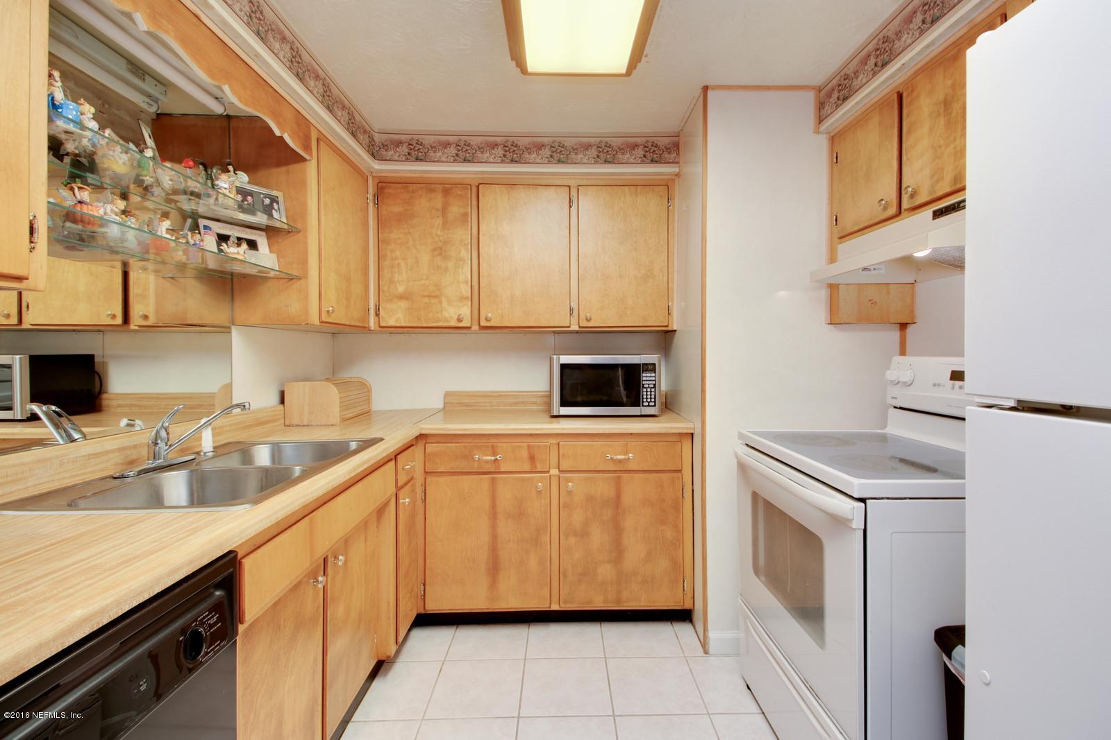 445 Sigsbee Road Orange Park, FL 32073 - Photo 8 of 32 a kitchen with a sink stove and cabinets