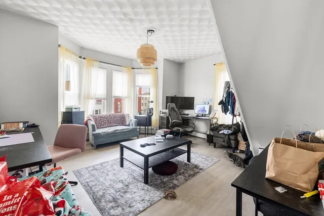 a bed room with two beds and a desk