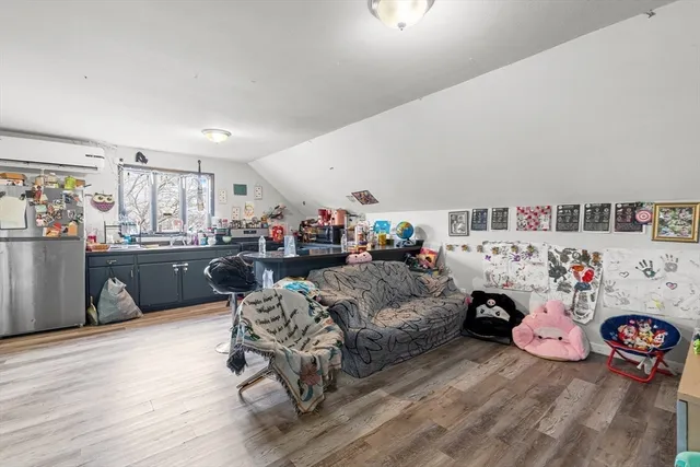 a view of a livingroom with fridge and workspace