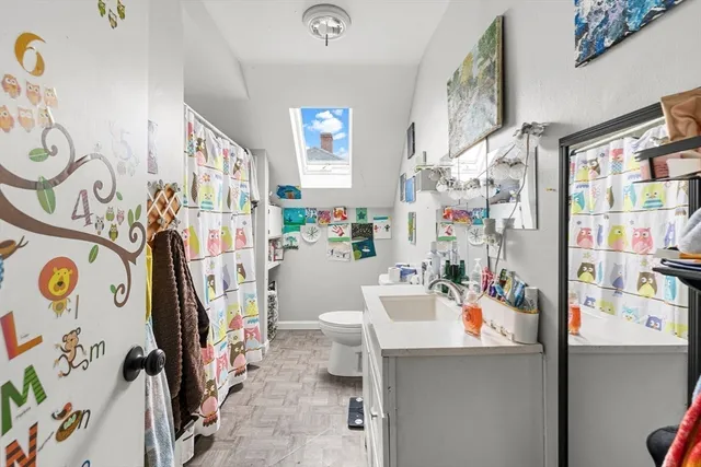 a bedroom with a bed wooden floor and a mirror