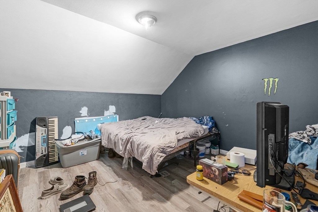 640 South Main Street Fall River, MA 02721 - Photo 27 of 33 a bedroom with a bed wooden floor and a mirror