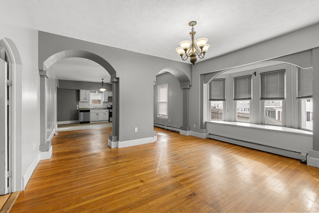 640 South Main Street Fall River, MA 02721 - Photo 5 of 33 a view of a room with wooden floor staircase and a living room