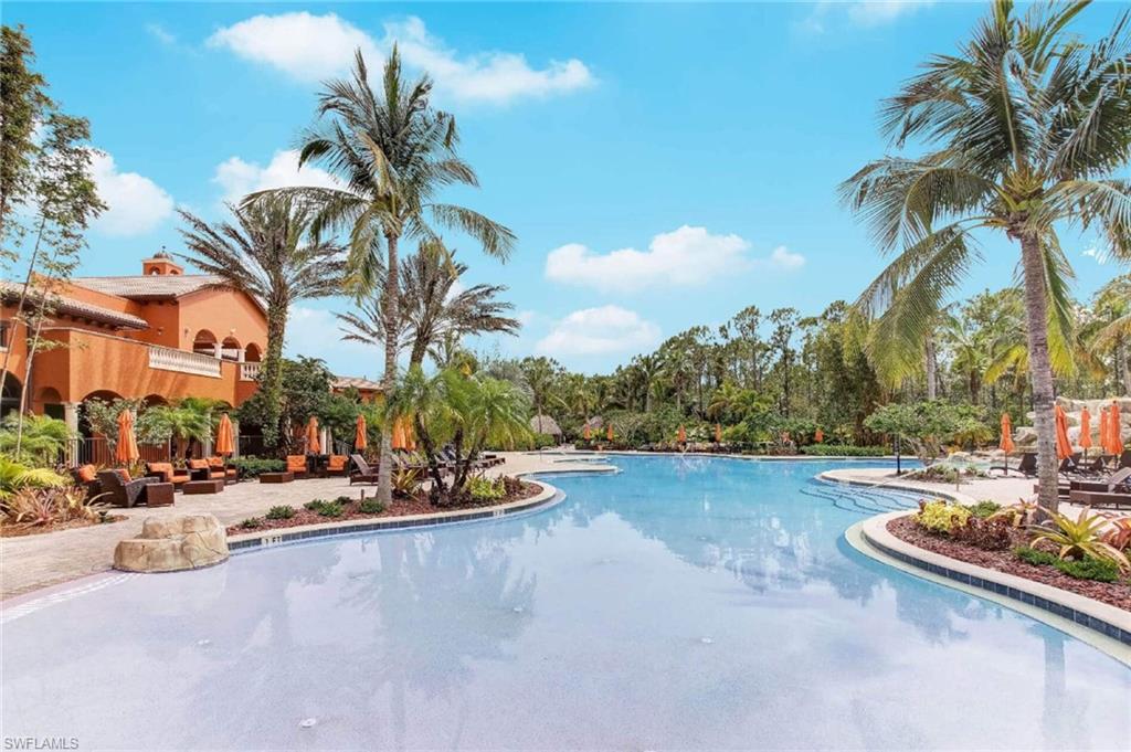 9076 Rialto Street, Unit 6204 Naples, FL 34113 - Photo 45 of 50 Expansive custom pool with a curved design and a surrounding paver patio