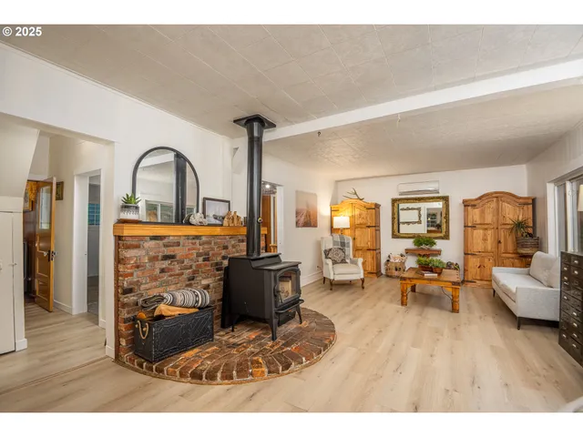 a living room with furniture a table and wooden floor