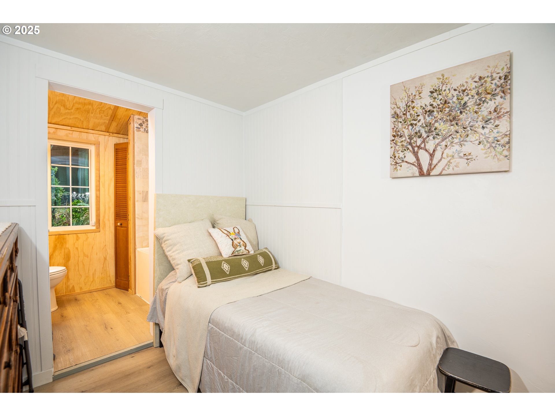 29 Neal Loop Toledo, OR 97391 - Photo 20 of 45 a bedroom with a bed and a painting on the wall