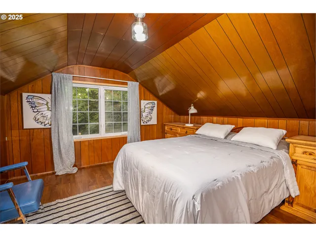 a bedroom with a bed and a night stand