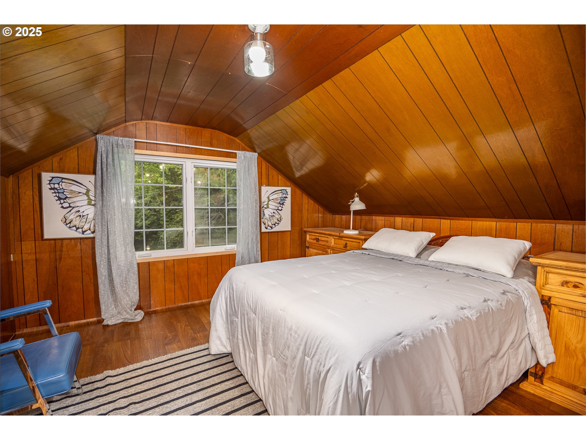 29 Neal Loop Toledo, OR 97391 - Photo 24 of 45 a bedroom with a bed and wooden floor