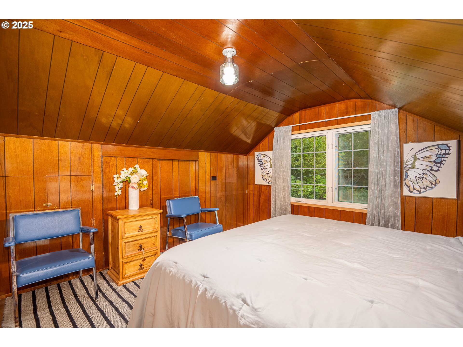 29 Neal Loop Toledo, OR 97391 - Photo 26 of 45 a bedroom with a bed and wooden floor