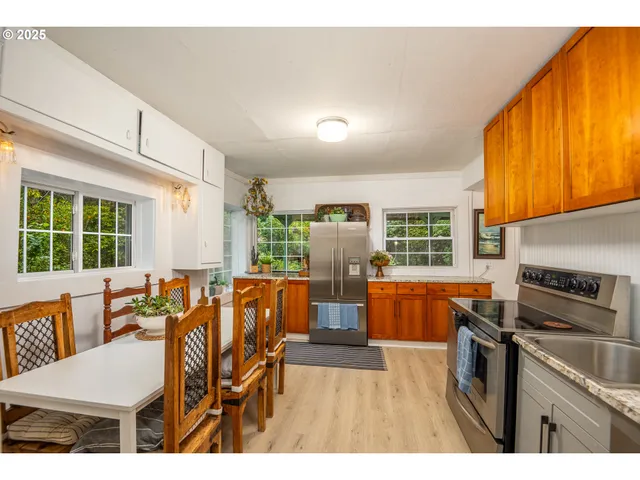 a kitchen with stainless steel appliances granite countertop a refrigerator and a sink