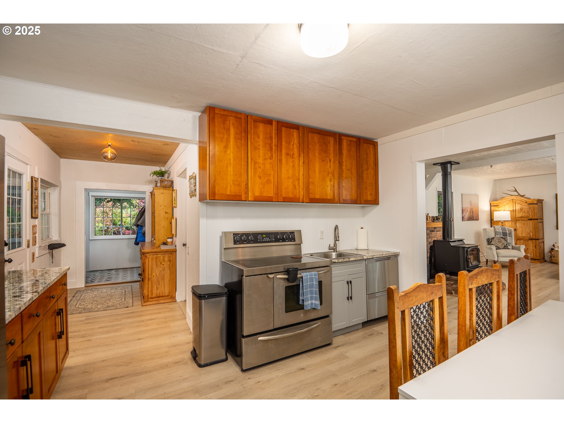 29 Neal Loop Toledo, OR 97391 - Photo 9 of 45 a kitchen with stainless steel appliances granite countertop a stove a sink dishwasher and a refrigerator with wooden floor