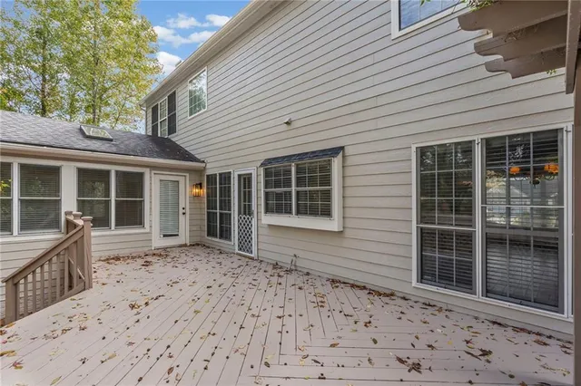 a view of backyard with small cabin and wooden fencing