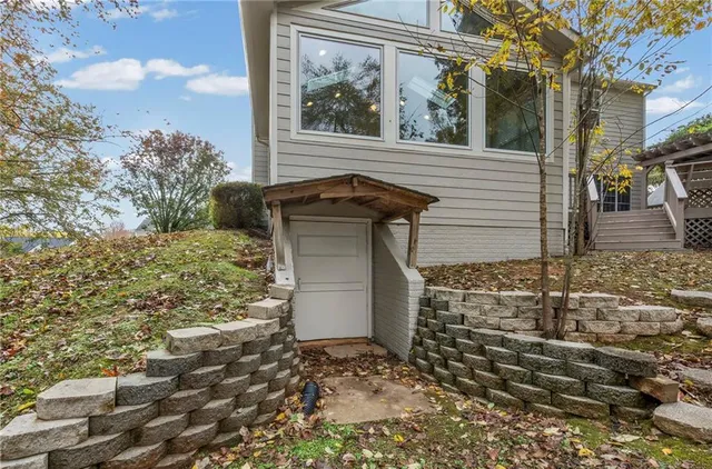 a front view of a house with yard and green space