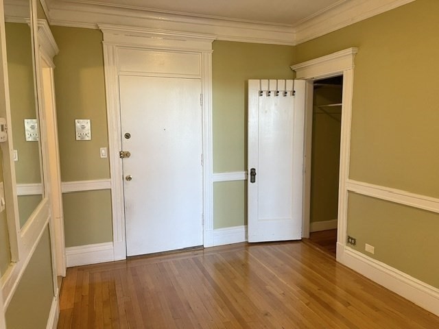464 Commonwealth Avenue, Unit 72 Boston, MA 02215 - Photo 7 of 18 an empty room with wooden floor and closet