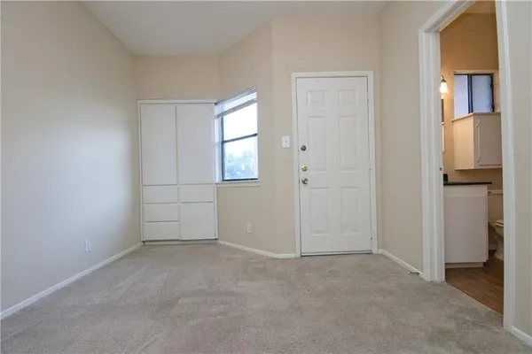an empty room with windows and closet