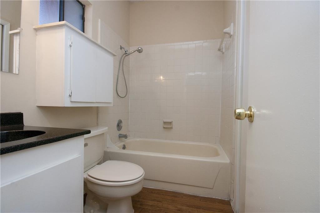 2818 Nueces Street, Unit 302 Austin, TX 78705 - Photo 5 of 6 a bathroom with a sink a toilet and shower