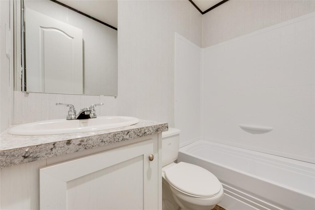 60 Tecumseh Road Valley View, TX 76272 - Photo 13 of 17 a bathroom with a granite countertop sink toilet and a mirror
