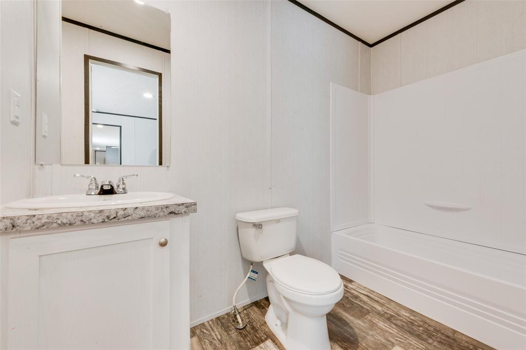 60 Tecumseh Road Valley View, TX 76272 - Photo 16 of 17 a bathroom with a granite countertop sink toilet and shower