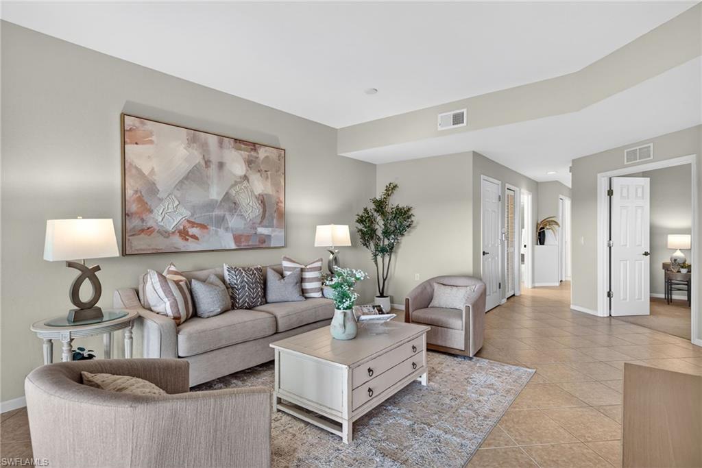 Living area with light tile patterned floors and baseboards
