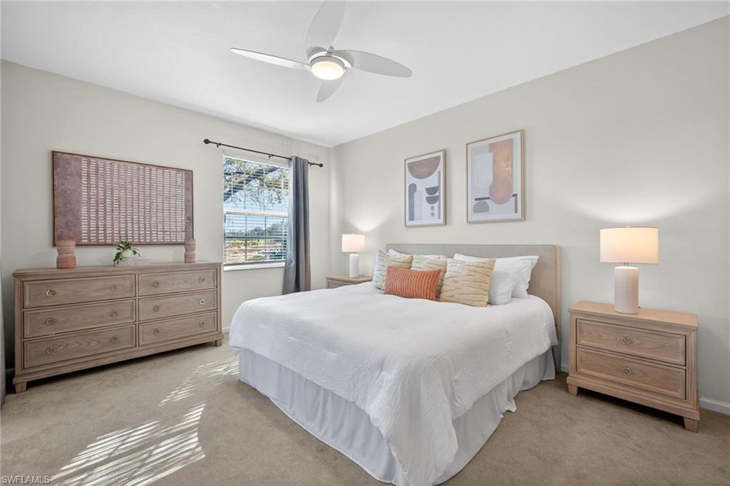 9201 Palmetto Ridge Drive, Unit 101 Estero, FL 34135 - Photo 12 of 29 Carpeted bedroom with ceiling fan