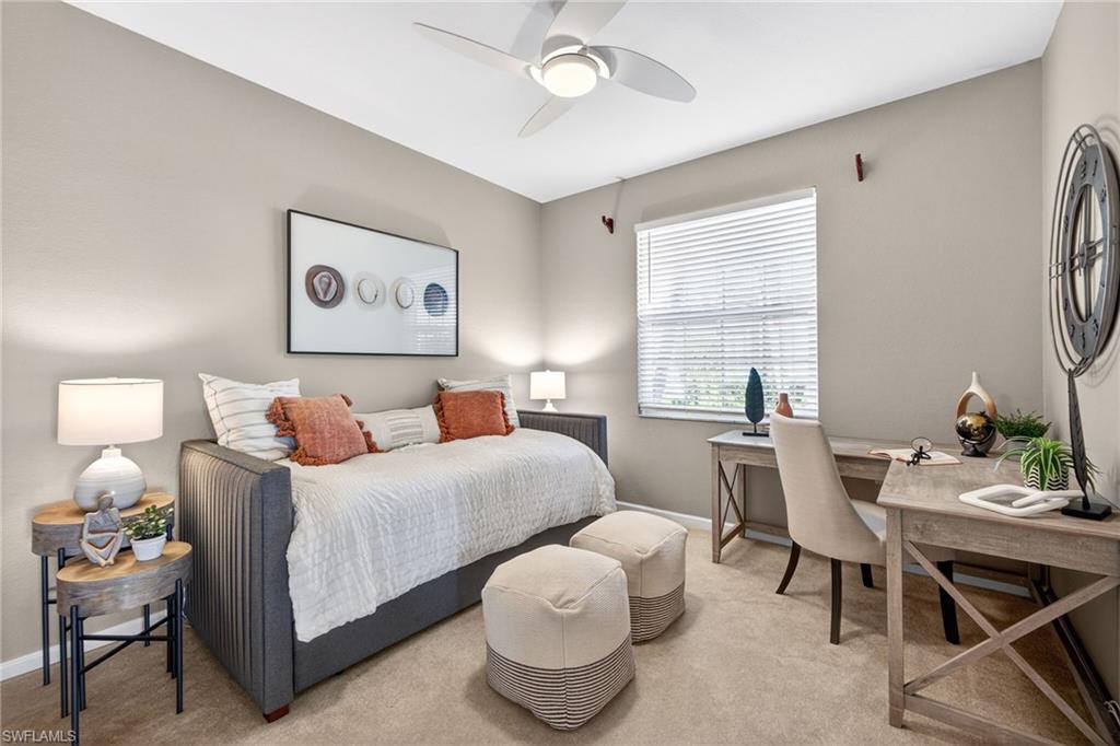 9201 Palmetto Ridge Drive, Unit 101 Estero, FL 34135 - Photo 17 of 29 Bedroom featuring light colored carpet, an office area, and a ceiling fan